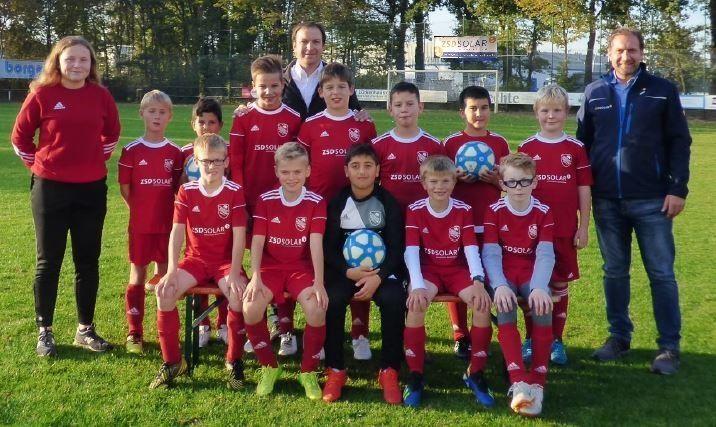 Kinder-Fußballmanschaft in roten Trikots